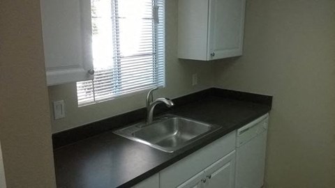 a kitchen with a sink and a window